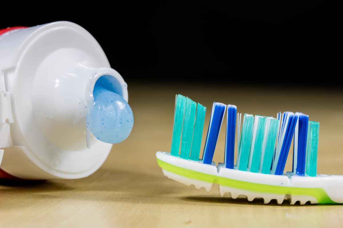 closeup of toothbrush bristles with open toothpaste
